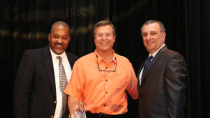 James Willard (center) accepts the award on behalf of Shutts & Bowen. Jim is pictured with Orlando Sentinel Publisher & Editor-In-Chief Avido Khahaifa and Orlando Sentinel Vice President of Advertising John D&rsquo;Orlando. (Photo credit: Ricardo Ramirez Buxeda, Orlando Sentinel)